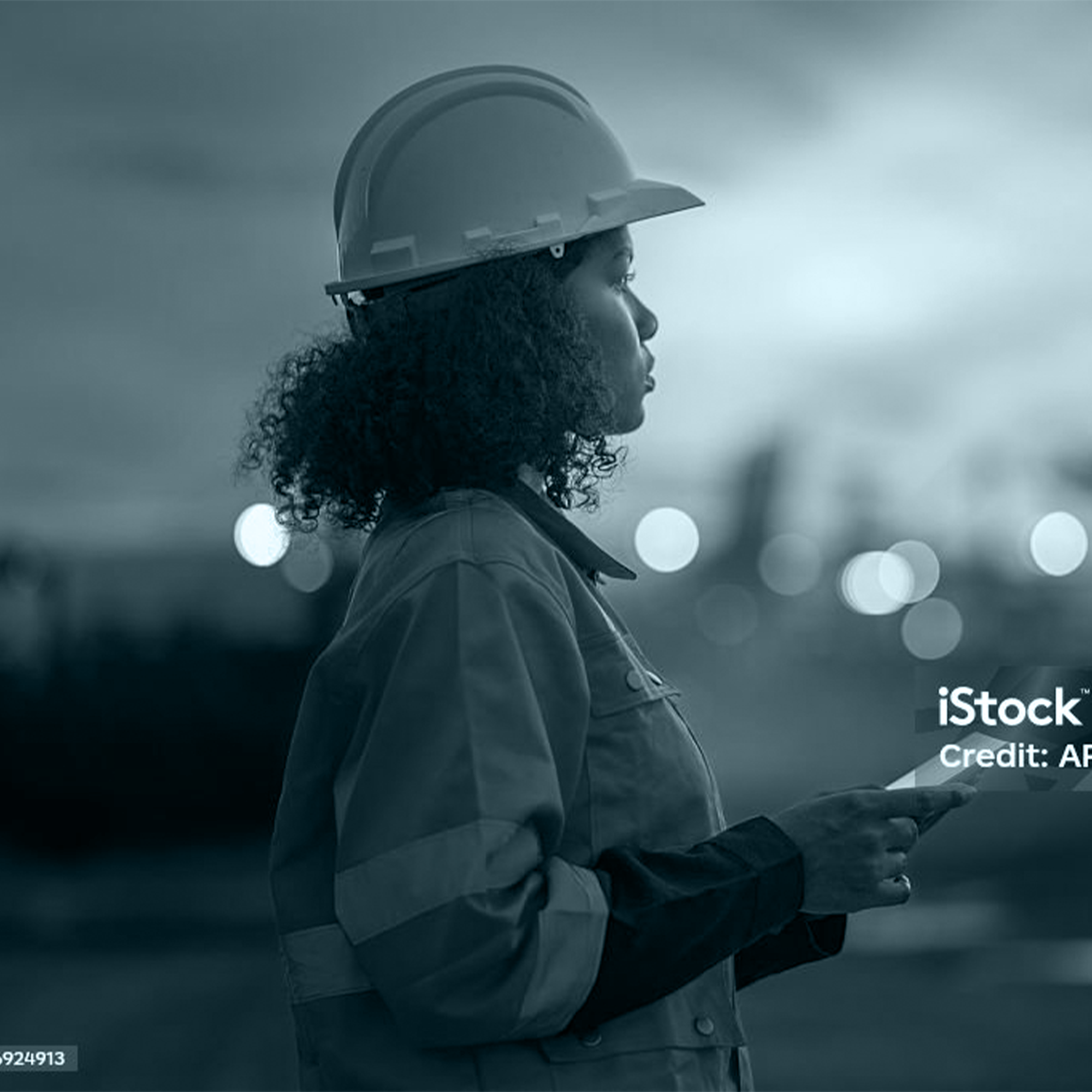 Engineer using tablet at dusk